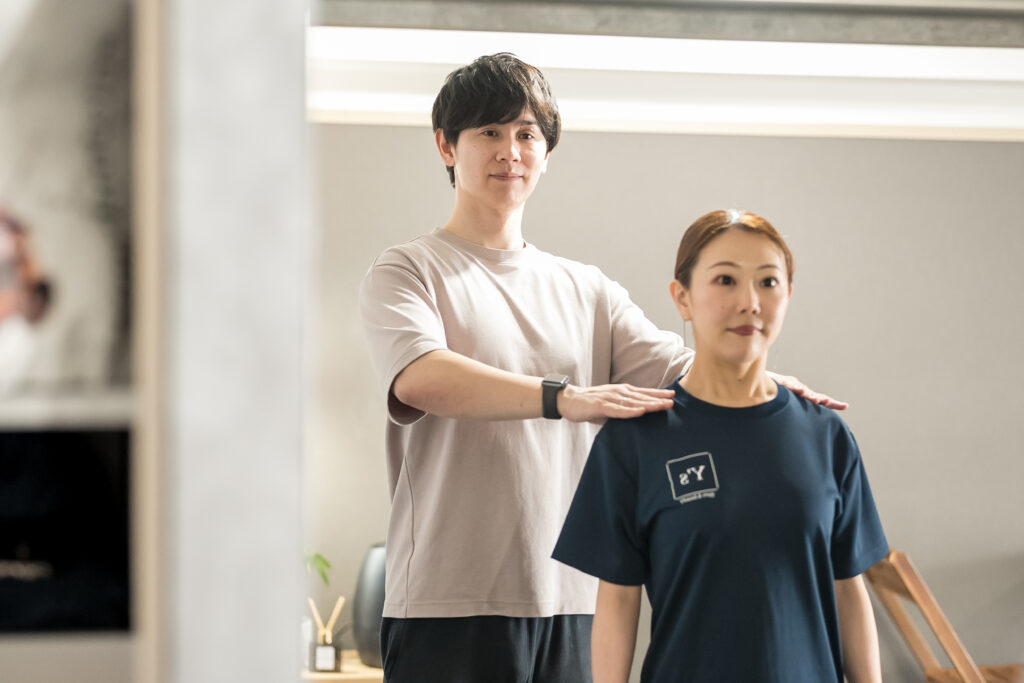 お客様とトレーナーが一緒に立ち姿勢を確認している様子